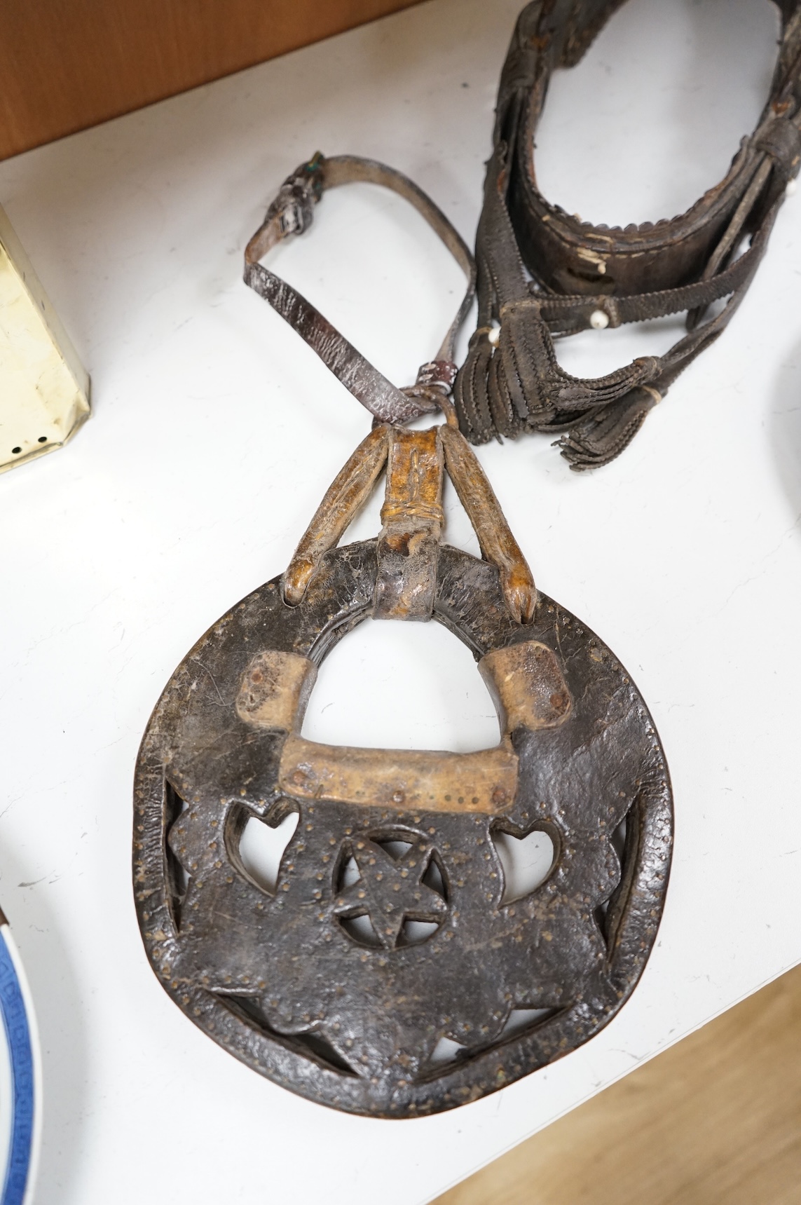 A pair of Argentinian Gaucho leather and piqué work stirrups together with a similar brass mounted belt